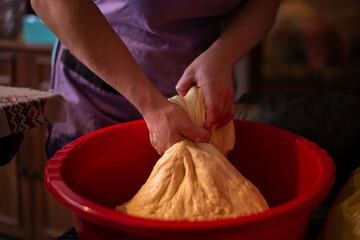 housewife kneading the dough by hand. preparation of the recipe for traditional Romanian homemade cakes known as cozonac