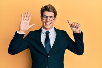 Handsome caucasian man wearing business suit and tie showing and pointing up with fingers number six while smiling confident and happy.