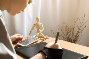 Modern technology, woman artist sketching of human head on phone with graphic tablet