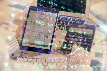 Double exposure of man's hands holding and using a digital device and forex graph drawing. Financial market concept.