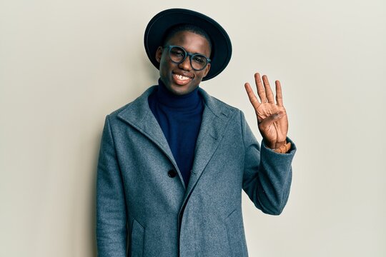 Young african american man wearing elegant style showing and pointing up with fingers number four while smiling confident and happy.