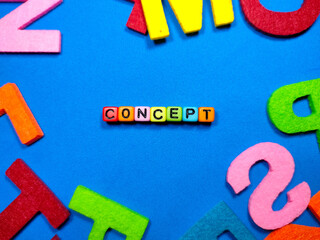 Selective focus.Colorful dice with word CONCEPT on blue background.Shot were noise and film grain.