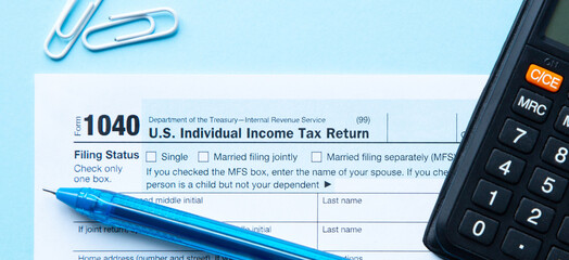 Close up 1040 Individual Income Tax Return with pen and calculator. Tax Form 1040. US Tax Concept 