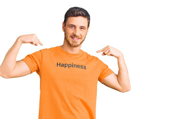 Handsome young man with bear wearing tshirt with happiness word message looking confident with smile on face, pointing oneself with fingers proud and happy.