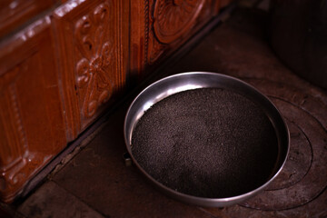 a tray of dried poppy seeds placed on the stove