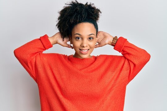Young african american girl wearing casual clothes relaxing and stretching, arms and hands behind head and neck smiling happy