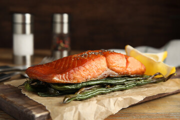 Tasty cooked salmon and vegetables served on wooden table. Healthy meals from air fryer