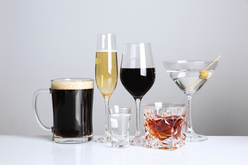 Many different alcoholic drinks on white background
