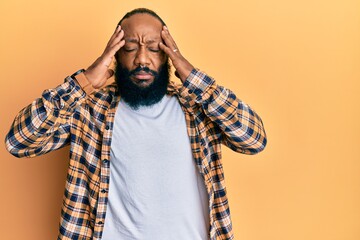 Young african american man wearing casual clothes with hand on head, headache because stress. suffering migraine.