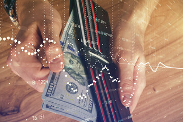 Double exposure of technology drawing hologram and us dollars bills and man hands. Data concept