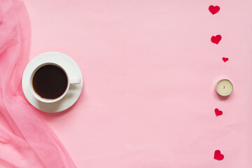 ladies pink background with coffee cup, red hearts and candles, top view