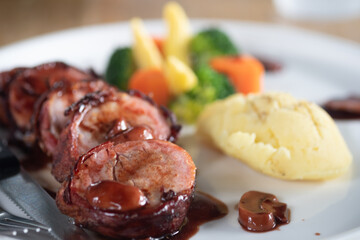 Bacon rolled steak served with potato and vegetable delicious