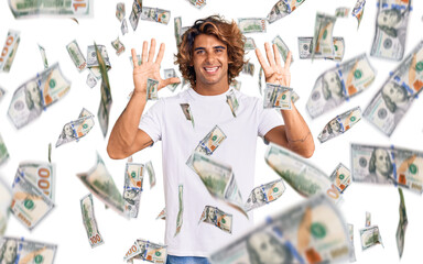 Young hispanic man wearing casual white tshirt showing and pointing up with fingers number nine...