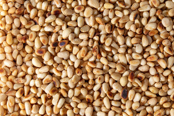 Full frame macro shot of ingredient roasted pine nuts.