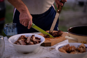 Slicing pork barbecue recipe on a hand made vintage chopping board