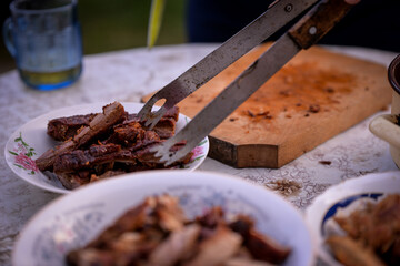 Slicing pork barbecue recipe on a hand made vintage chopping board