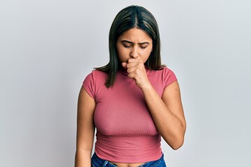 Young latin woman wearing casual clothes feeling unwell and coughing as symptom for cold or...