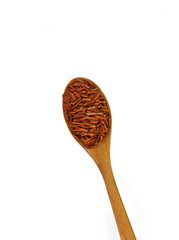 Heap of red rice in a wooden spoon isolated on white background, food