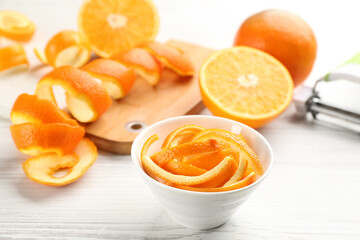 Fototapeta na wymiar Orange fruits and peels on white wooden table