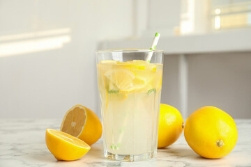 Cool freshly made lemonade and fruits on white marble table