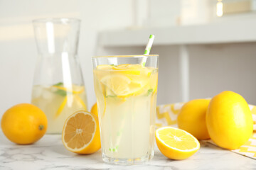 Cool freshly made lemonade and fruits on white marble table