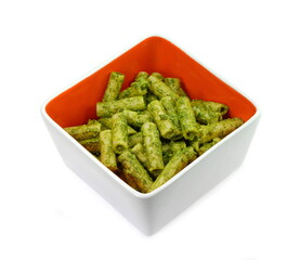 Italian Food. Pasta with original pesto green sauce in Genoa (Genova) Italy on white plate background, Pasta with basil pesto herbs background.