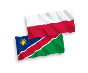 National vector fabric wave flags of Republic of Namibia and Poland isolated on white background. 1 to 2 proportion.