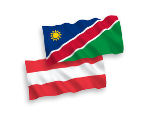 National vector fabric wave flags of Austria and Republic of Namibia isolated on white background. 1 to 2 proportion.