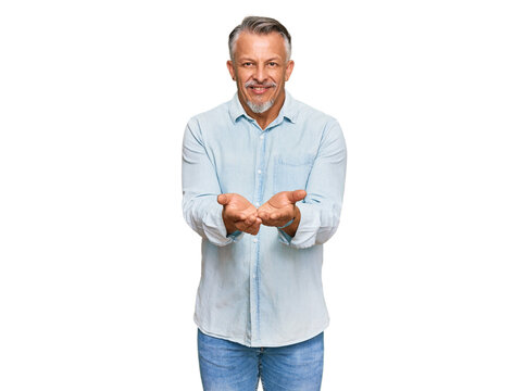 Middle age grey-haired man wearing casual clothes smiling with hands palms together receiving or giving gesture. hold and protection