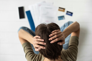Fototapeta premium Exhausted stressed woman looking at bills. Calculating family budget, crisis, finance, spending money concept