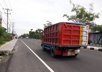 Fototapeta na wymiar truck on the highway, or truk lewat di jalan, Magelang, Jawa Tengah, Indonesia