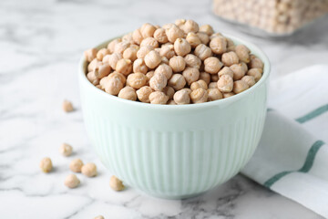 Chickpeas in bowl on white marble table