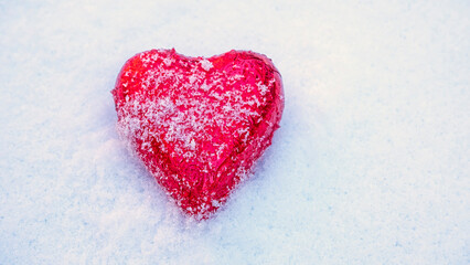 Red Valentine's heart in the snow