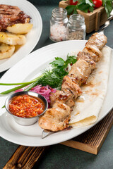 Chicken kebab with sauce and flatbread close-up