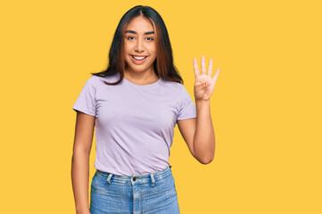 Young latin woman wearing casual clothes showing and pointing up with fingers number four while smiling confident and happy.