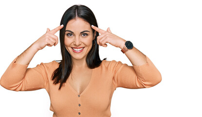 Young hispanic woman wearing casual clothes smiling pointing to head with both hands finger, great idea or thought, good memory