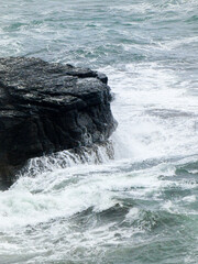 waves crashing and breaking on rocks