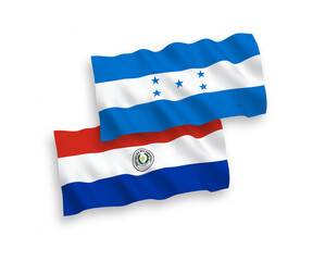 National vector fabric wave flags of Paraguay and Honduras isolated on white background. 1 to 2 proportion.
