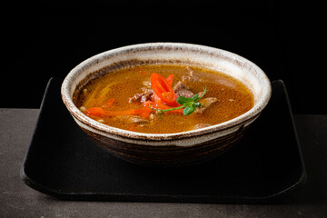 soup with beef and microgreens