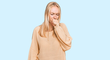 Young blonde girl wearing casual clothes feeling unwell and coughing as symptom for cold or...