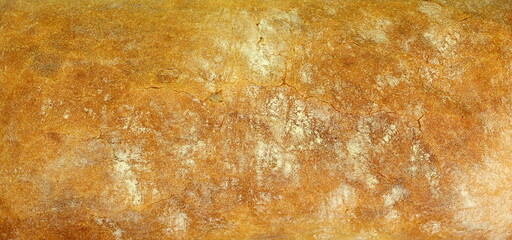 Texture of bread made from wheat flour with a delicious gold crust close-up. Photo of food.