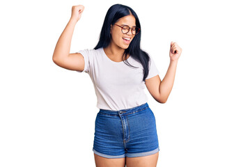 Obraz na płótnie Canvas Young beautiful asian girl wearing casual clothes and glasses dancing happy and cheerful, smiling moving casual and confident listening to music