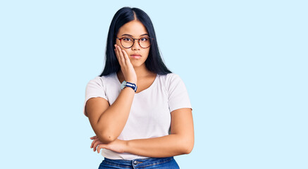 Young beautiful asian girl wearing casual clothes and glasses thinking looking tired and bored with depression problems with crossed arms.