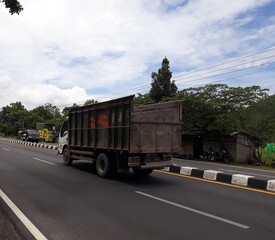 Fototapeta na wymiar truck on the highway, or truk lewat di jalan, Magelang, Jawa Tengah, Indonesia