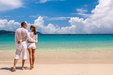 Couple in white on a beach - 415376430
