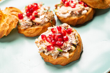 canape with meat salad and pomegranate seeds