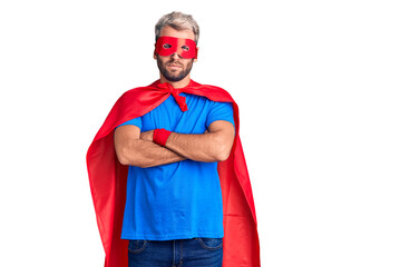 Young blond man wearing super hero custome skeptic and nervous, disapproving expression on face...