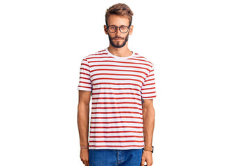 Fototapeta premium Handsome blond man with beard wearing casual clothes and glasses looking sleepy and tired, exhausted for fatigue and hangover, lazy eyes in the morning.