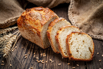 Freshly baked traditional bread on wooden table.