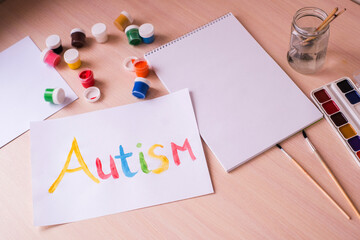 Creative design for april 2, autism world awareness day.  Painting word autism with paints